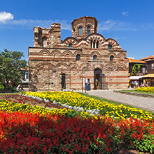 NESSEBAR, BULGARIA - AUGUST 12, 2018: Flower garden in front of Ancient Church of Christ Pantocrator in the town of Nessebar, Burgas Region, Bulgaria