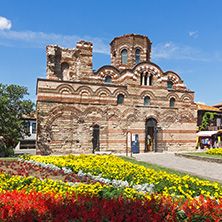 NESSEBAR, BULGARIA - AUGUST 12, 2018: Flower garden in front of Ancient Church of Christ Pantocrator in the town of Nessebar, Burgas Region, Bulgaria