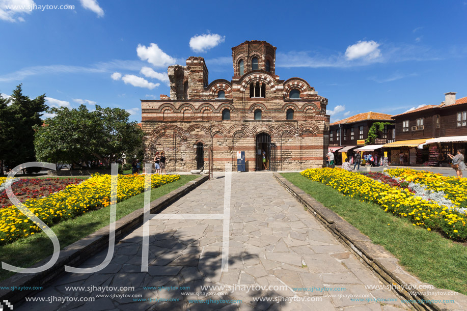 NESSEBAR, BULGARIA - AUGUST 12, 2018: Flower garden in front of Ancient Church of Christ Pantocrator in the town of Nessebar, Burgas Region, Bulgaria