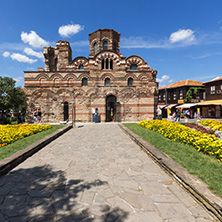 NESSEBAR, BULGARIA - AUGUST 12, 2018: Flower garden in front of Ancient Church of Christ Pantocrator in the town of Nessebar, Burgas Region, Bulgaria