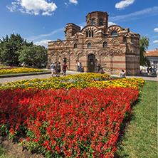 NESSEBAR, BULGARIA - AUGUST 12, 2018: Flower garden in front of Ancient Church of Christ Pantocrator in the town of Nessebar, Burgas Region, Bulgaria