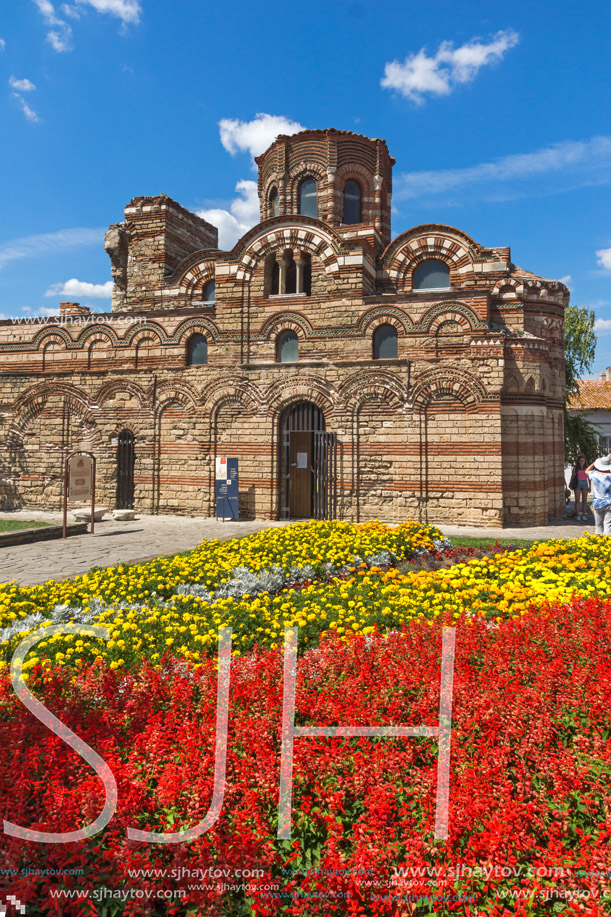 NESSEBAR, BULGARIA - AUGUST 12, 2018: Flower garden in front of Ancient Church of Christ Pantocrator in the town of Nessebar, Burgas Region, Bulgaria