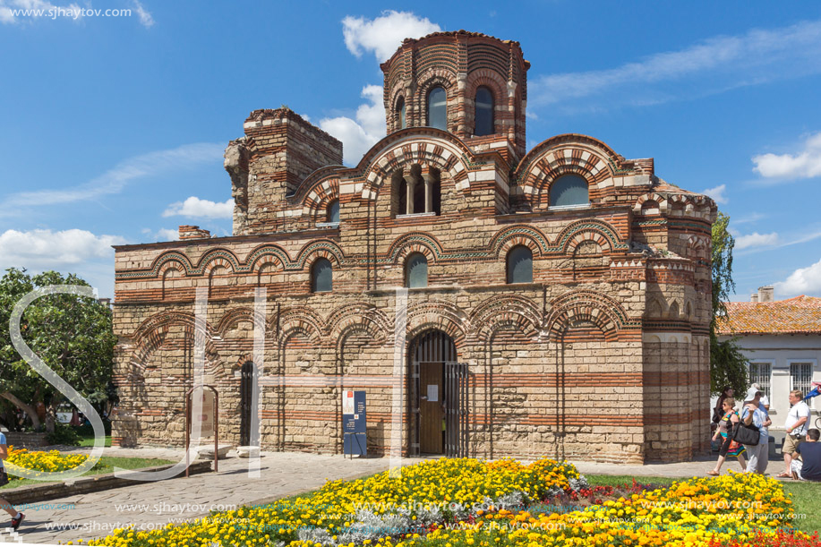 NESSEBAR, BULGARIA - AUGUST 12, 2018: Flower garden in front of Ancient Church of Christ Pantocrator in the town of Nessebar, Burgas Region, Bulgaria