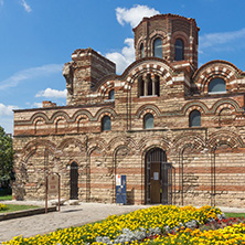 NESSEBAR, BULGARIA - AUGUST 12, 2018: Flower garden in front of Ancient Church of Christ Pantocrator in the town of Nessebar, Burgas Region, Bulgaria