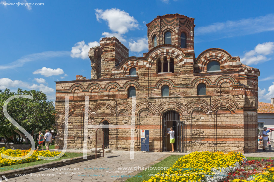 NESSEBAR, BULGARIA - AUGUST 12, 2018: Flower garden in front of Ancient Church of Christ Pantocrator in the town of Nessebar, Burgas Region, Bulgaria