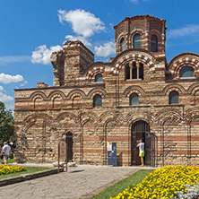 NESSEBAR, BULGARIA - AUGUST 12, 2018: Flower garden in front of Ancient Church of Christ Pantocrator in the town of Nessebar, Burgas Region, Bulgaria