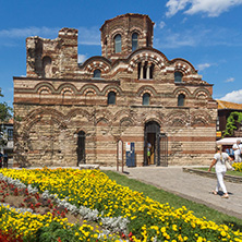 NESSEBAR, BULGARIA - AUGUST 12, 2018: Flower garden in front of Ancient Church of Christ Pantocrator in the town of Nessebar, Burgas Region, Bulgaria