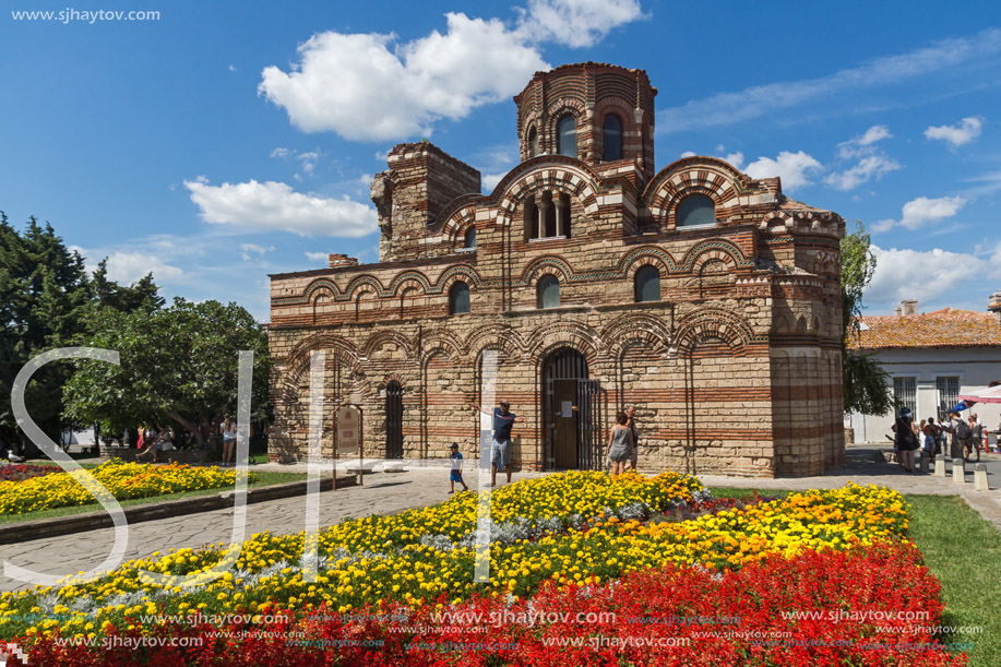 NESSEBAR, BULGARIA - AUGUST 12, 2018: Flower garden in front of Ancient Church of Christ Pantocrator in the town of Nessebar, Burgas Region, Bulgaria