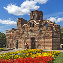 NESSEBAR, BULGARIA - AUGUST 12, 2018: Flower garden in front of Ancient Church of Christ Pantocrator in the town of Nessebar, Burgas Region, Bulgaria